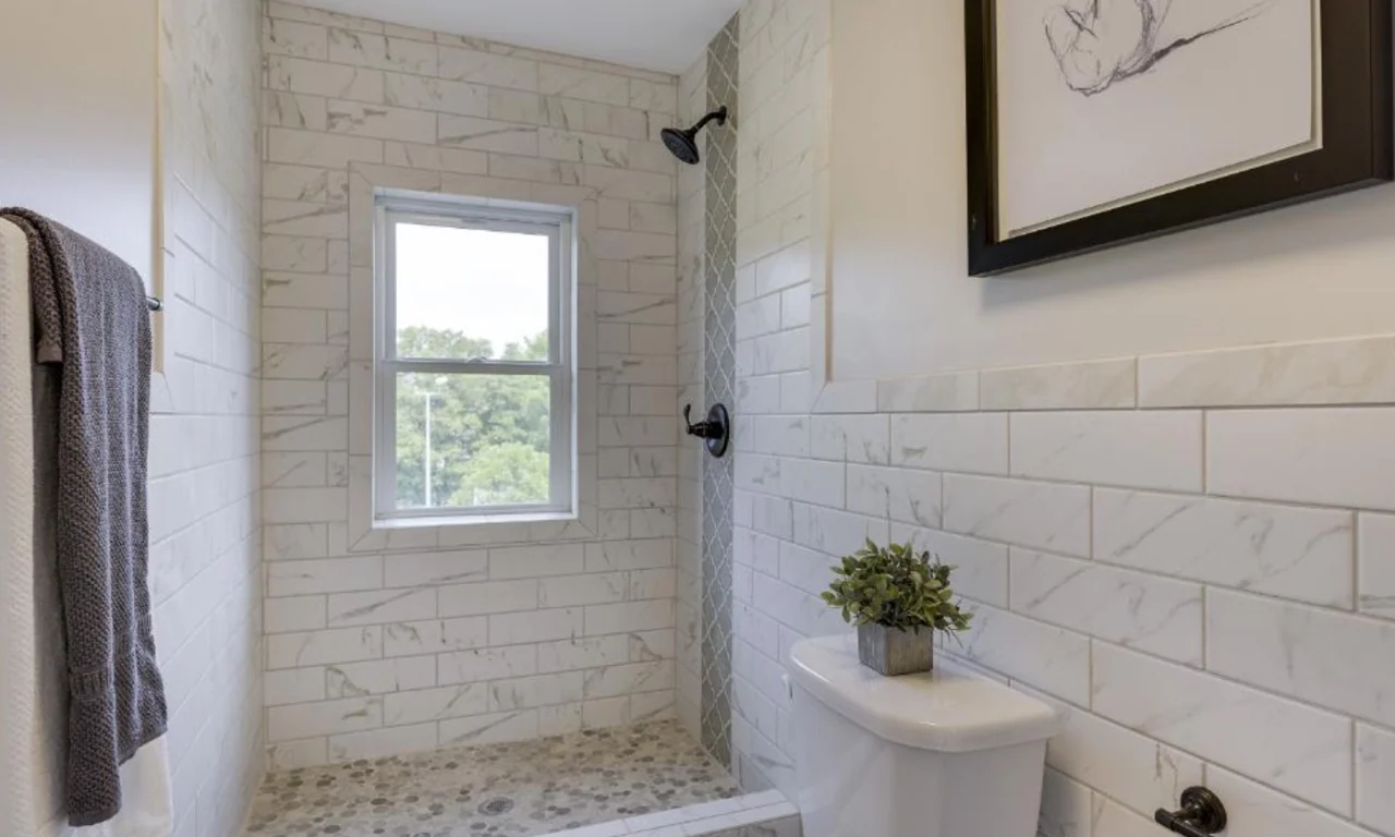 Fully retiled bathroom in the 79 Western condominium renovation in Saint Paul